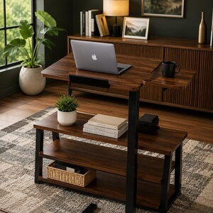 May include: A height-adjustable standing desk with a dark wood grain finish and a black metal frame. The desk features a main work surface, a side shelf, and two lower storage shelves. A laptop, a black mug, a small potted plant, and books are present.