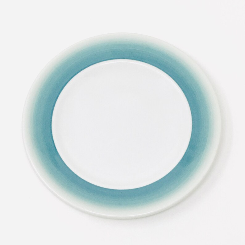 May include: A set of three ceramic vases in varying heights. The vases are white with a textured, ribbed design. The tallest vase is approximately 10 inches tall, the medium vase is 8 inches, and the smallest is 6 inches.