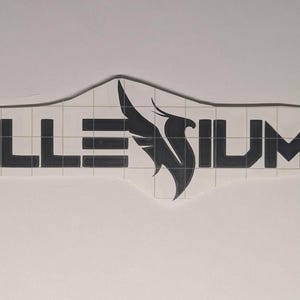 May include: A black vinyl decal featuring the text ILLENIUM with a stylized phoenix bird graphic replacing the letter E. The design is presented on a white backing paper with a grid pattern, showing the cut lines for the adhesive sticker.