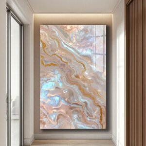 May include: Abstract wall art featuring a swirling design in shades of beige, gold, and blue. The artwork has a glossy finish and is displayed in a hallway setting. The design incorporates flowing lines and a marbled effect.