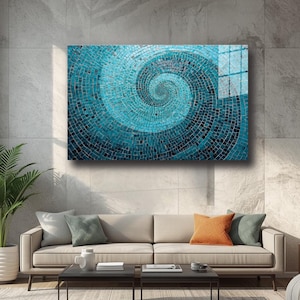 May include: A large, rectangular wall art piece featuring a mosaic design in shades of teal and blue. The mosaic forms a spiral pattern, creating a sense of depth and movement. The artwork is displayed above a beige sofa in a modern living room setting.