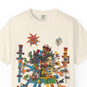 May include: Off-white t-shirt with a vibrant graphic print. The design showcases a multi-armed figure with intricate details, alongside symbols in blue, red, yellow, and green. The tee has a crew neck and short sleeves. A visual statement.