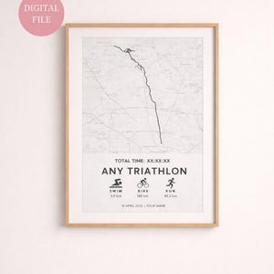 May include: Framed print with a map and the words "ANY TRIATHLON". The print includes icons for swim, bike, and run, with distances in kilometers. The text "DIGITAL FILE" is in a pink circle in the upper left corner.