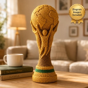 Könnte beinhalten: Eine goldgelbe Häkeltrophäe mit einer Weltkugel an der Spitze, die von drei stilisierten Figuren mit erhobenen Armen getragen wird. Der Sockel enthält ein horizontales grünes Band. Ein goldenes Siegel oben rechts zeigt den Text Diagram Images Included.