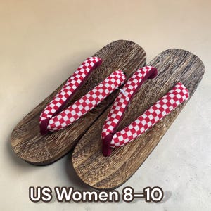 May include: A pair of wooden geta sandals with a textured brown finish. The straps are red and white checkered fabric. The text "US Women 8-10" is at the bottom of the image.