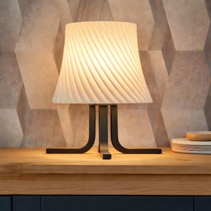 May include: A set of three ceramic mugs with a speckled, matte finish. The mugs are in shades of cream, light gray, and dark gray. Each mug has a simple, modern design and a rounded handle.