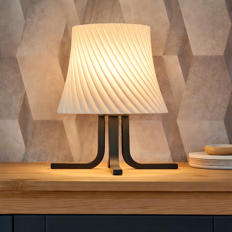 May include: A set of three ceramic mugs with a speckled, matte finish. The mugs are in shades of cream, light gray, and dark gray. Each mug has a simple, modern design and a rounded handle.