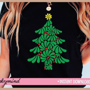 May include: Black t-shirt with a green and red Christmas tree design. The tree is made up of stylized leaves and red berries. The text "cheeky mind" is at the bottom left of the shirt and "INSTANT DOWNLOAD" is at the bottom right.