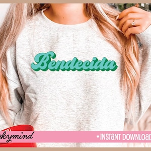 May include: A gray sweatshirt with the word "Bendecida" written in a retro, green and blue font.