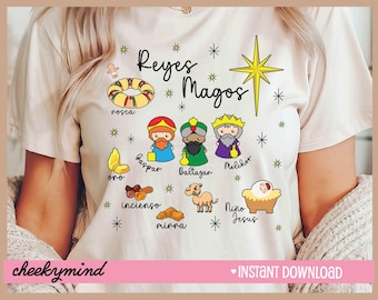 May include: White t-shirt with a cartoon illustration of the Three Wise Men, a star, and gifts. The text "Reyes Magos" is written in Spanish.