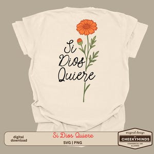 May include: Cream-colored t-shirt featuring the phrase "Si Dios Quiere" in black script, accompanied by an orange flower and green leaves. The design includes a digital download option and a "CHEEKYMINDS" logo.