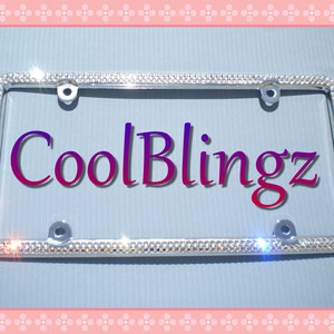 May include: A silver license plate frame with a diamond-like design. The frame has four holes for mounting and the text "CoolBlingz" is printed in the center.