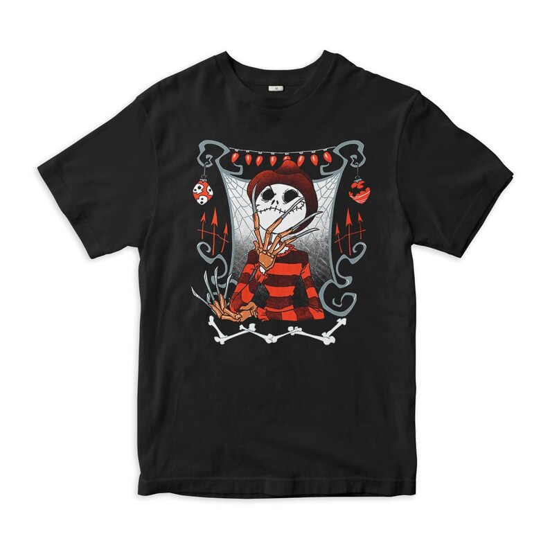 May include: A black short-sleeve t-shirt featuring a graphic print of a skeletal figure wearing a brown hat and a red and black striped sweater. The figure has long, sharp, blade-like fingers and is framed by red holiday lights and ornaments.