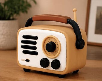 May include: A retro-style radio in a warm yellow hue with a white face. It features a brown handle, black knobs, and a small antenna. The design evokes a vintage aesthetic, perfect for home decor.