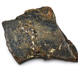 May include: A rough-hewn, irregularly shaped rock with a textured surface. The rock displays a mix of dark gray, brown, and gold colors, with areas of metallic sheen. The overall appearance suggests a natural mineral specimen.