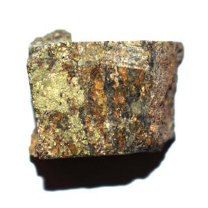 May include: A raw mineral specimen featuring a metallic gold-colored pyrite section contrasted with a rough, textured brown and dark gray rock matrix. The stone displays an irregular, blocky shape with visible crystalline surfaces and earthy tones.