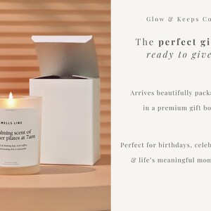 May include: A lit candle in a clear glass jar with a white label that reads "Smells Like the calming scent of reformer pilates at 7am." A white gift box is behind the candle. The text "Glow & Keeps Co" is at the top.