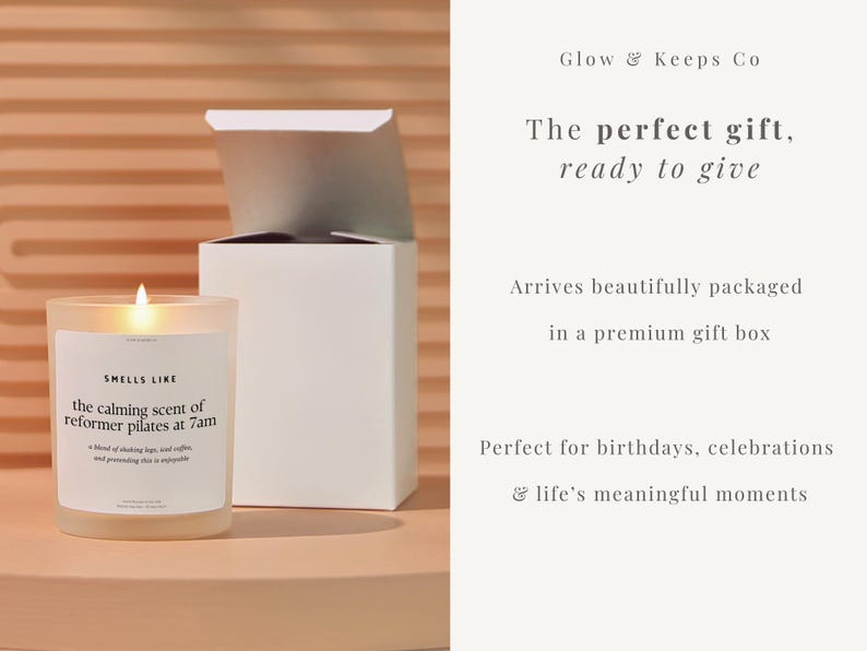 May include: A lit candle in a clear glass jar with a white label that reads "Smells Like the calming scent of reformer pilates at 7am." A white gift box is behind the candle. The text "Glow & Keeps Co" is at the top.