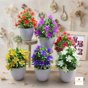 May include: Six potted artificial plants with flowers in orange, purple, magenta, red, yellow, and white, each in a smooth light grey pot. The plants feature green leaves and are arranged on a tiered wooden stand with a framed sign featuring red text.