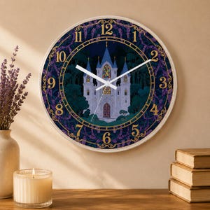 May include: A round wall clock featuring a castle illustration. The clock face has a dark blue background with a castle in the center, surrounded by a purple floral border and gold numerals. The clock hands are white.