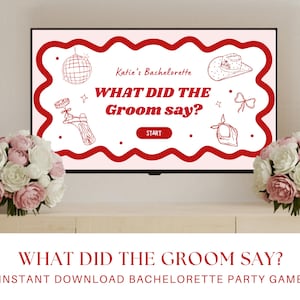 May include: A television screen displays a bachelorette party game titled "What Did The Groom Say?" in red text. The screen has a red wavy border and features illustrations of a disco ball, cowboy hat, and other party-themed graphics. Bouquets of pink and white flowers flank the screen.