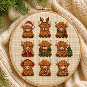 May include: A circular wooden embroidery hoop containing a cross-stitch pattern of nine brown Highland cows. Each cow features different holiday accessories, including a Santa hat, reindeer antlers, a scarf, a gift, a wreath, a tree, earmuffs, a candy cane, and a bell.