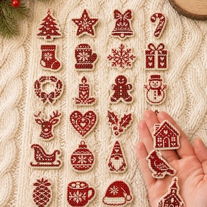 May include: A collection of small, red and white cross-stitch embroidered patches featuring various holiday icons including a Christmas tree, star, bell, candy cane, stocking, mitten, snowflake, gift, wreath, candle, gingerbread man, snowman, reindeer, heart, holly, sleigh, ornament, gnome, pinecone, mug, hat, house, bird, and church.