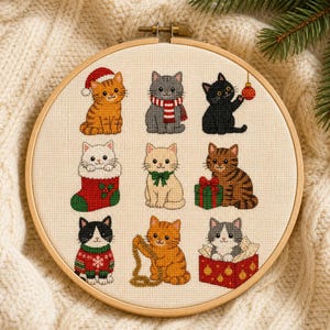 Può includere: Un telaio da ricamo circolare in legno contenente un motivo a punto croce di nove gatti a tema natalizio. I gatti includono un soriano arancione con cappello da Babbo Natale, un gatto grigio con sciarpa e un gatto nero con una decorazione.