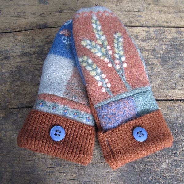 Sweater mittens: felted wool mittens in rust and blues with embroidered flowers and blue buttons.