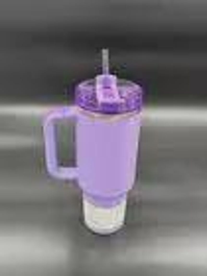 May include: A lavender-colored tumbler with a handle and a straw. The tumbler has a textured lid and a white base. The handle is square and the straw is gray. The tumbler is designed to keep drinks cold.
