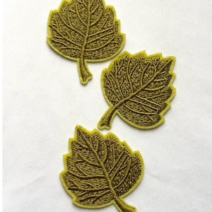 May include: Three embroidered leaf patches in a dark olive green color. Each patch features a detailed stitched vein pattern and a solid light olive green border, shaped like a serrated leaf with a small stem at the bottom of each piece.
