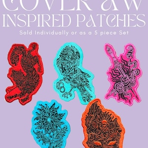 May include: Five embroidered patches featuring intricate black line art on vibrant backgrounds. Designs include a wolf, an owl, a dagger, a floral motif, and a mask. The text at the top reads COVER AW INSPIRED PATCHES. Sold Individually or as a 5 piece Set.
