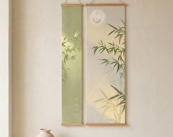 Puede incluir: Dos pergaminos de pared verticales con marcos de madera que muestran ilustraciones de bambú verde, un pájaro pequeño, una luna llena y caracteres chinos. El pergamino izquierdo es verde claro y el derecho es crema con detalles texturizados.