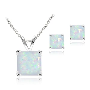 May include: A silver necklace with a square opal pendant and matching square opal stud earrings. The opal stones have a white base with iridescent flashes of color. The jewelry set is displayed on a white background.