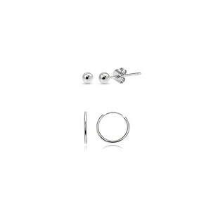 May include: A set of three pairs of silver earrings. The top row features two ball stud earrings and a single stud earring. The bottom row shows a pair of small hoop earrings. All earrings are displayed against a white background.