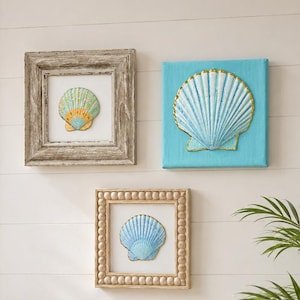 May include: Three wall art pieces featuring seashell motifs. One square frame has a weathered wood finish, one is a bright turquoise canvas, and one is a square frame with a beaded border. Each displays a single, detailed, textured seashell.