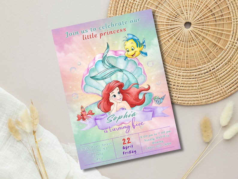 May include: A colorful invitation featuring Ariel from The Little Mermaid, a seashell, and a yellow fish. The invitation reads "Join us to celebrate our little princess" and "Sophia is turning five."