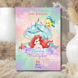 May include: A colorful invitation featuring Ariel from The Little Mermaid. The invitation reads "Join us to celebrate our little princess" and includes the text "Sophia is turning five". The date is April 22nd.