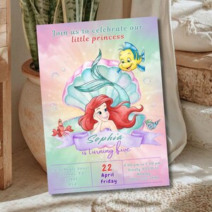 May include: A colorful invitation for a little princess's fifth birthday, featuring Ariel from The Little Mermaid. The design includes a mermaid, a seashell, and the text "Join us to celebrate our little princess". The invitation also includes the name "Sophia" and the date.