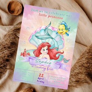 May include: A colorful invitation card featuring a mermaid, a fish, and a seashell. The text "Join us to celebrate our little princess" is at the top. The invitation is for Sophia's fifth birthday, with the date April 22nd.