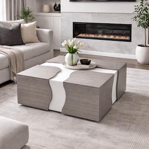 Peut inclure: Une table basse moderne au design unique. La table présente une finition en bois gris avec des accents blancs. Un vase de tulipes blanches et un petit bol sont posés dessus. La table est dans un salon.