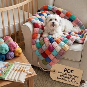 May include: A vibrant, patchwork-style crochet blanket on a cream armchair, with a small white dog resting on it. Balls of yarn in various colours, crochet hooks, and a book are nearby. A tag reads "PDF DIGITAL PATTERN DOWNLOAD - ENGLISH VERSION."