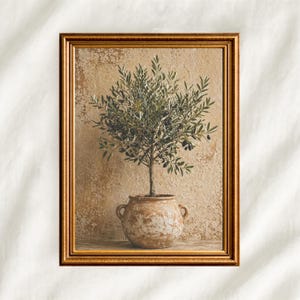 May include: A framed print of an olive tree in a terracotta pot. The tree has green leaves and dark olives against a textured, beige background. The gold-coloured frame enhances the botanical artwork's aesthetic appeal.