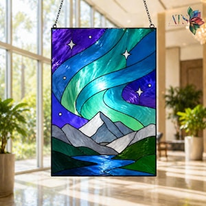 May include: Stained glass panel depicting an aurora borealis scene. The artwork features a vibrant display of blues, greens, and purples, with white stars and snow-capped mountains. A river flows through the landscape.