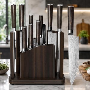 May include: A set of kitchen knives with dark wood handles and silver bolsters, featuring patterned Damascus steel blades. The knives are stored in a dark wooden block stand, with one large chef knife positioned upright in the foreground.