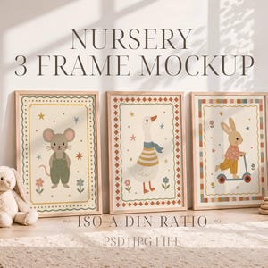 May include: Three framed nursery art prints featuring a mouse, goose, and rabbit. The artwork has a vintage style with soft colors and decorative borders. The frames are light wood, and the overall theme is a children's room.