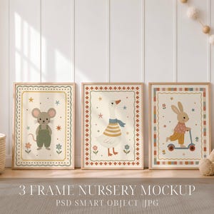 May include: Three framed wall art prints featuring illustrations of a mouse in green overalls, a goose wearing a blue scarf, and a rabbit riding a blue scooter. Each print is bordered by a decorative pattern with stars and flowers on a cream background.