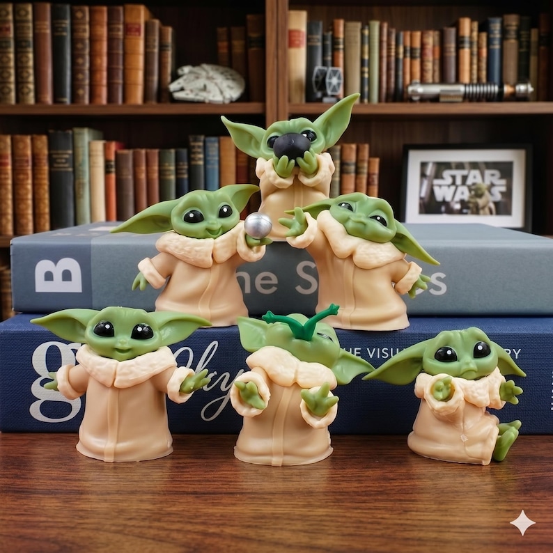 May include: A collection of six small green figurines with large ears and black eyes, each wearing a tan robe with a cream-colored collar. The figures are posed in various actions, including holding a silver sphere, eating, and reaching out.