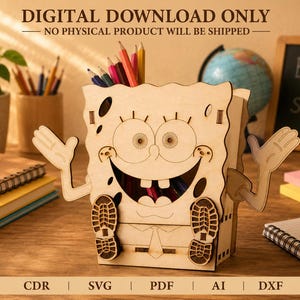 May include: A light-colored wooden pencil holder shaped like a cartoon character with large eyes, a wide smile, and raised arms. The front features cut-out details for the face, shoes, and tie, with an open top for storing pens and pencils.