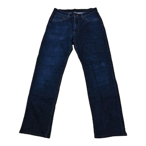 May include: Dark wash denim jeans with a classic five-pocket design. The jeans have a straight leg cut and a button and zipper closure. The denim has a slightly faded appearance.